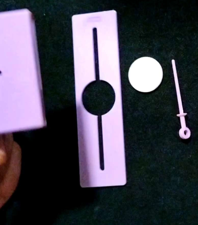 Close-up of a razor and accessories on a dark surface