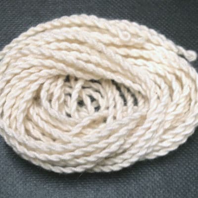 Coiled white rope on a dark gray background