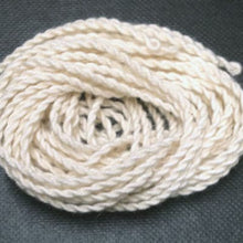 Coiled white rope on a dark gray background