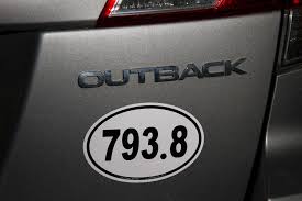 Outback decal on a vehicle with a personalized license plate number.