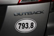 Outback decal on a vehicle with a personalized license plate number.