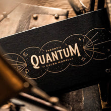 Black box with 'Quantum' branding on a wooden surface