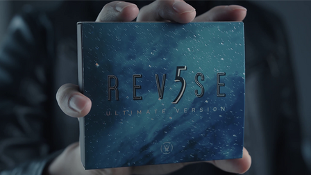 Hand holding a blue box with 'REV5SE' branding against a dark background