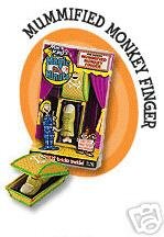 Mummified Monkey Finger product packaging on an orange background