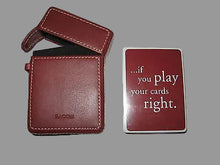 Red leather cardholder with a playing card displaying text on a white background