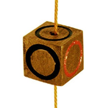 Wooden block with black and red circles on a string against a white background