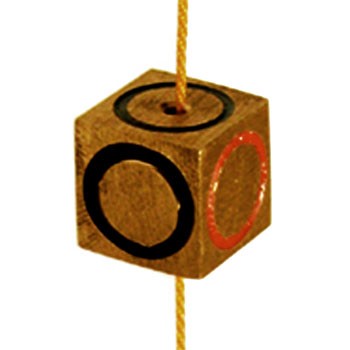 Wooden block with black and red circles on a string against a white background