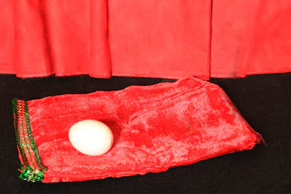 Red pouch with a white ball on a black background