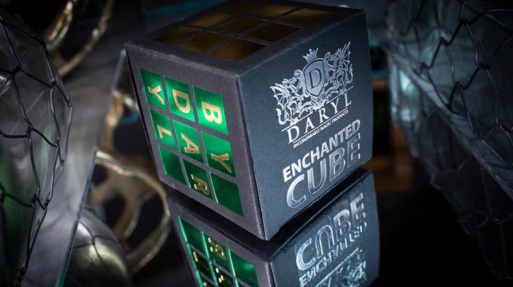 Daryl Enchanted Cube with green and blue lights on a reflective surface