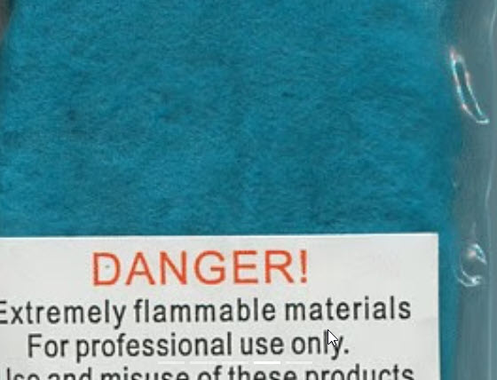 Blue material with a warning label about flammability.
