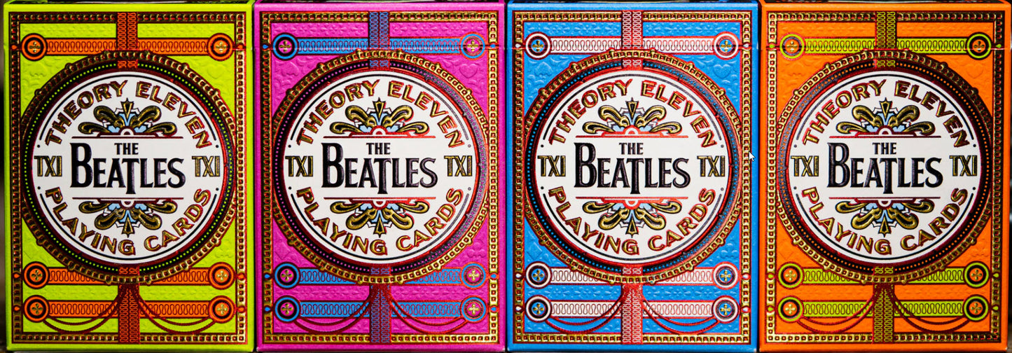 Four colorful packaging designs for The Beatles playing cards.