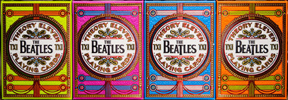 Four colorful packaging designs for The Beatles playing cards.
