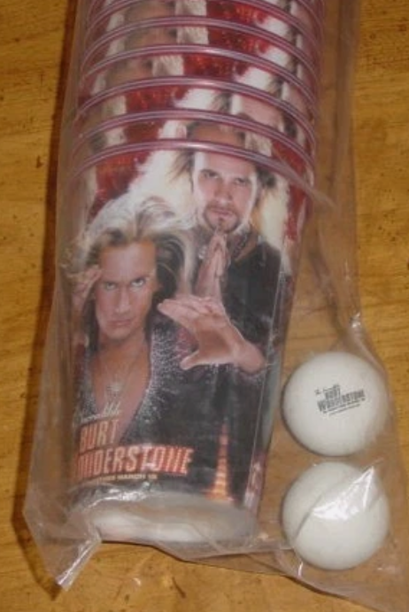 Packaged product with a character from a movie or TV show and two white balls on a wooden surface.