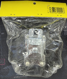 Clear plastic component in a clear bag with a yellow label on a dark surface