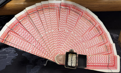 Fanned-out deck of cards with a black box on a dark surface