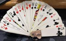 Fanned-out deck of playing cards on a dark surface