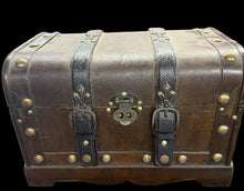 Vintage-style wooden trunk with metal accents in a store setting