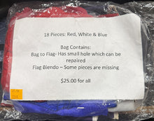 Packaged flag set with red, white, and blue colors, showing a small hole in the bag.