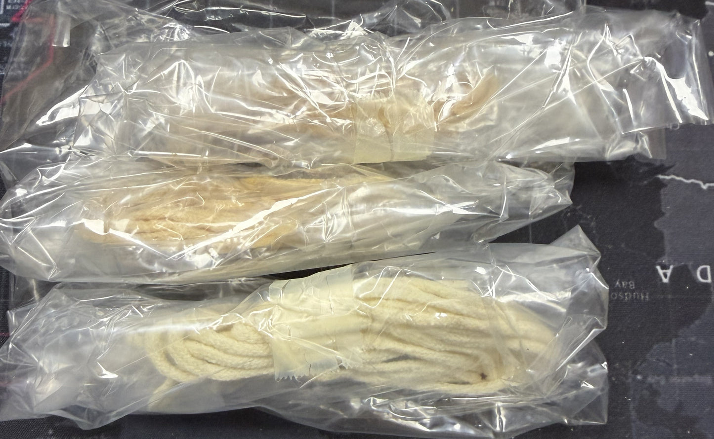 Two packages of white noodles on a dark surface