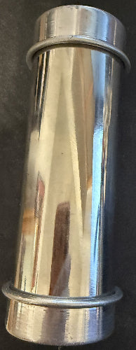 Metallic cylindrical object with reflective surface on a dark background