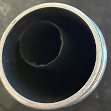 Close-up of a metallic pipe with a dark interior