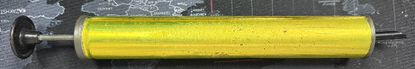 Yellow cylindrical object with a black shaft on a map background
