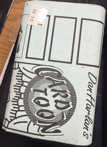 Vintage notebook with 'Darfurian' design and text on a wooden surface