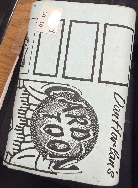 Vintage notebook with 'Darfurian' design and text on a wooden surface