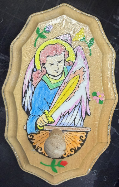 Decorative patch with an angel design on a dark surface