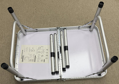 Metallic folding chair with a white cushion on a beige background