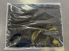 Clear plastic wrap covering a rectangular object on a gray surface