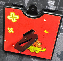 Small red book with cartoon characters on a map background