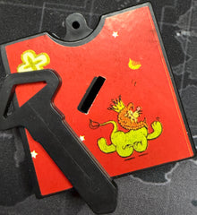 Red tool with a green frog design on a camouflage background