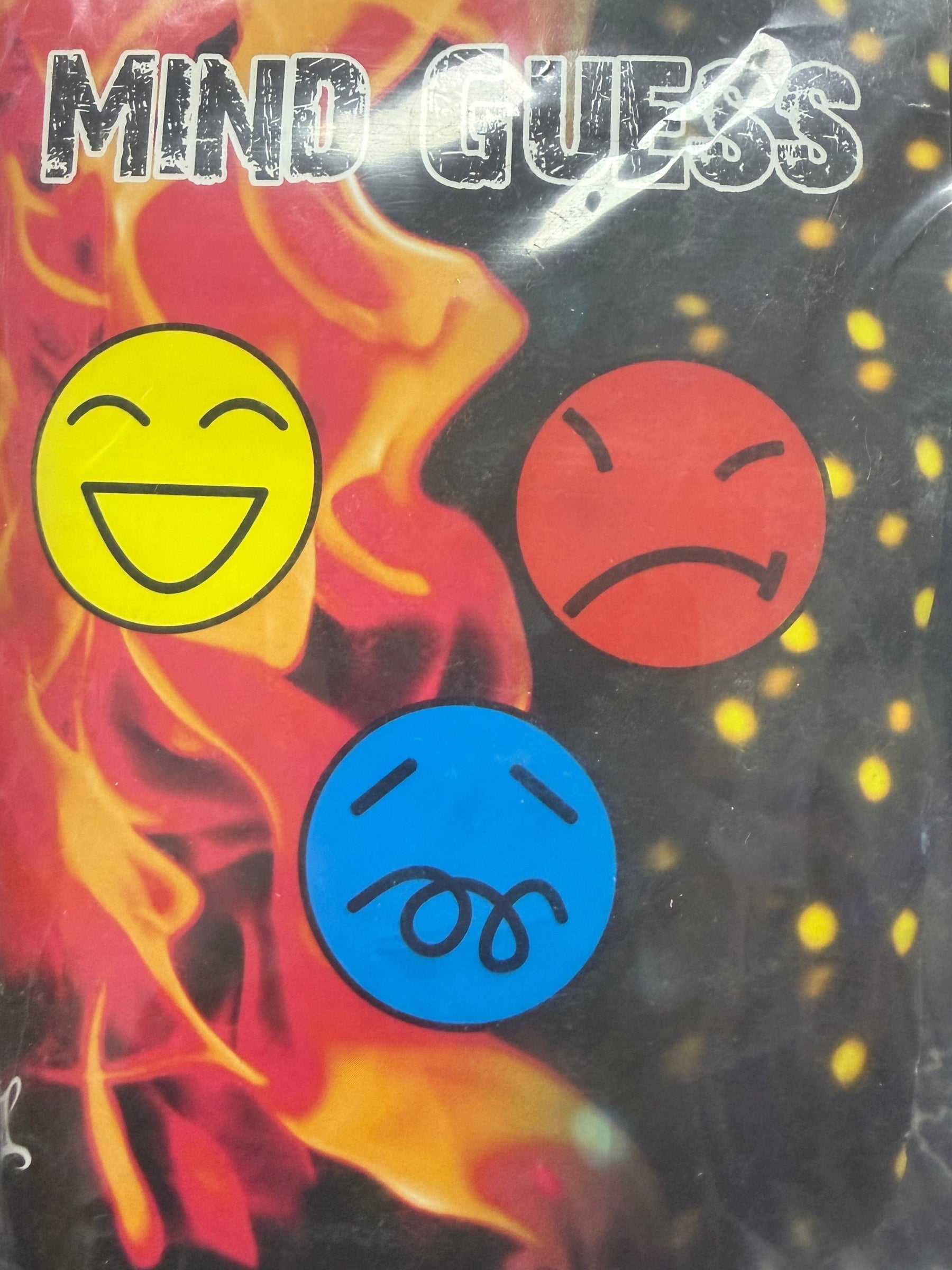 Packaged product with colorful smiley face symbols and text on a black background