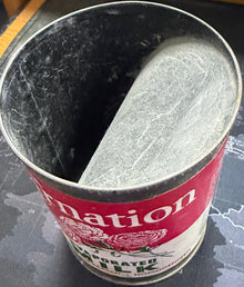 Metal can with red label on a textured surface