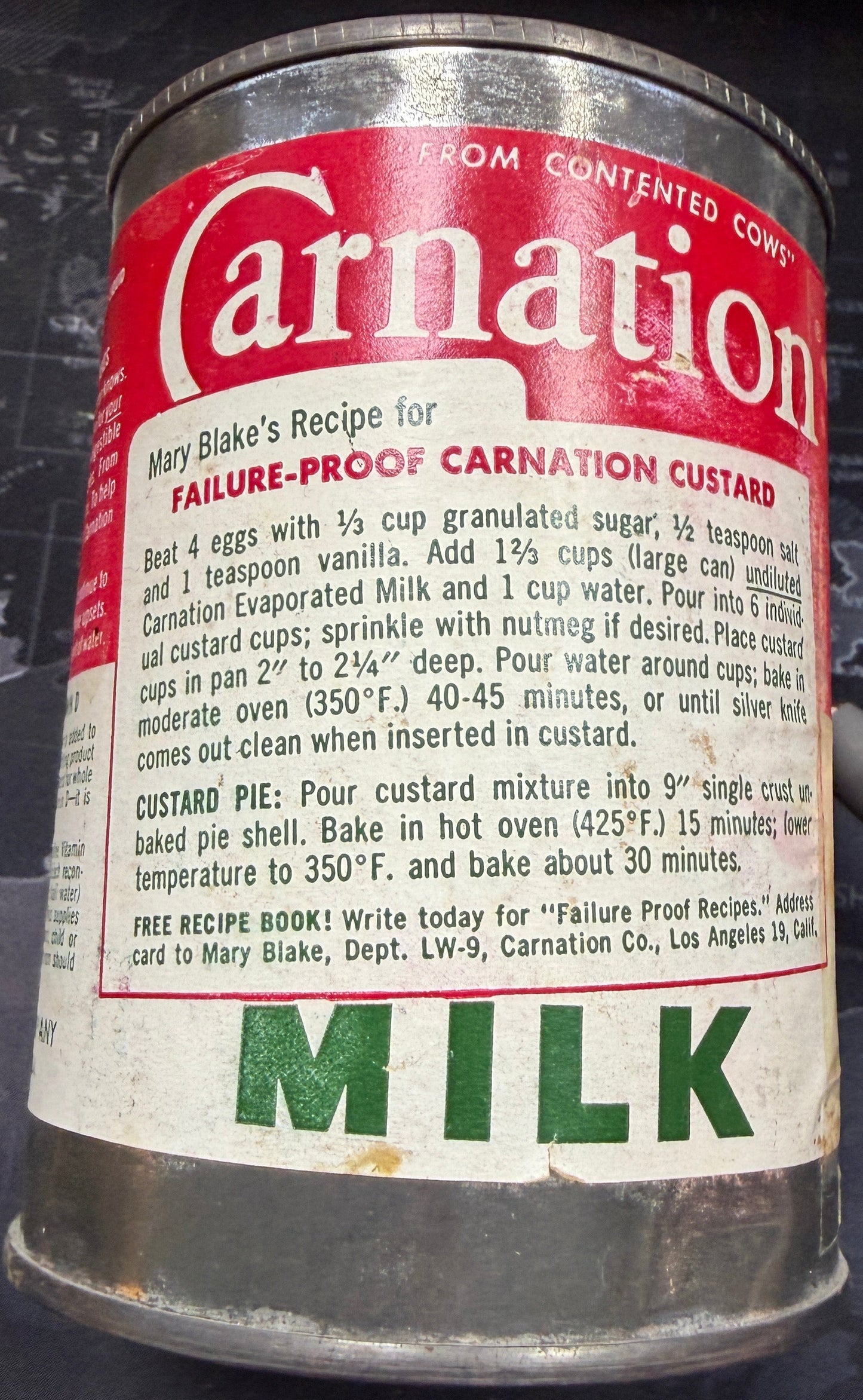 Vintage Carnation milk can on a dark surface