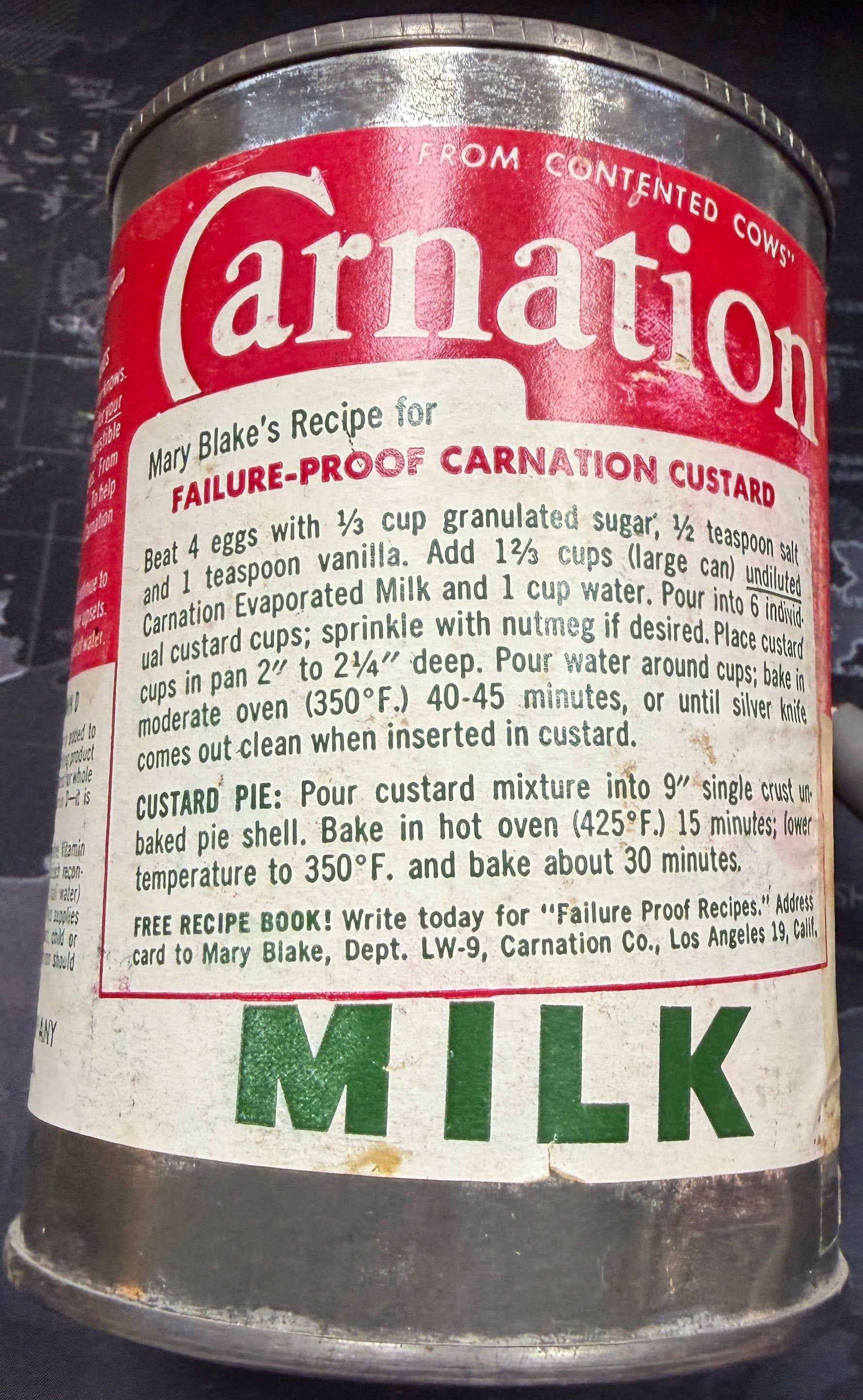 Vintage Carnation milk can on a dark surface