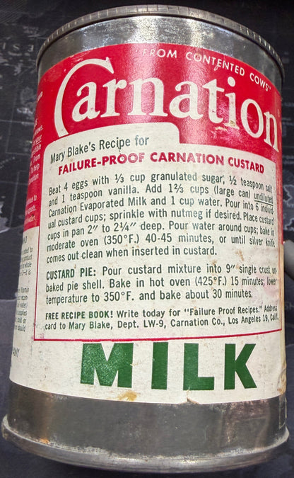 Vintage Carnation milk can on a dark surface