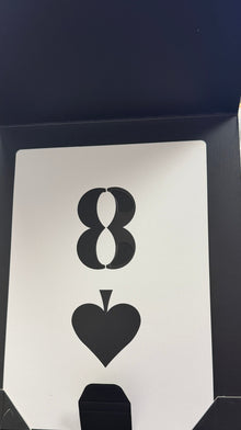 Playing card with infinity symbol and heart shape on a black frame