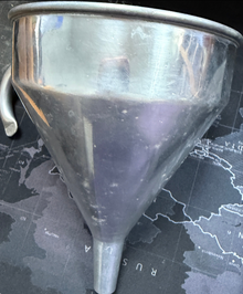 Metal funnel on a map background