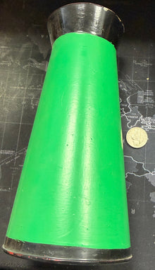 Green cylindrical object on a map with a coin for scale