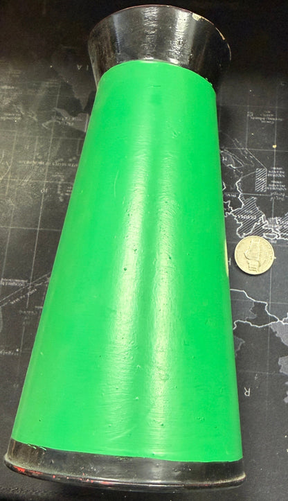 Green cylindrical object on a map with a coin for scale