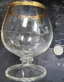 Clear glass with gold rim on a world map background