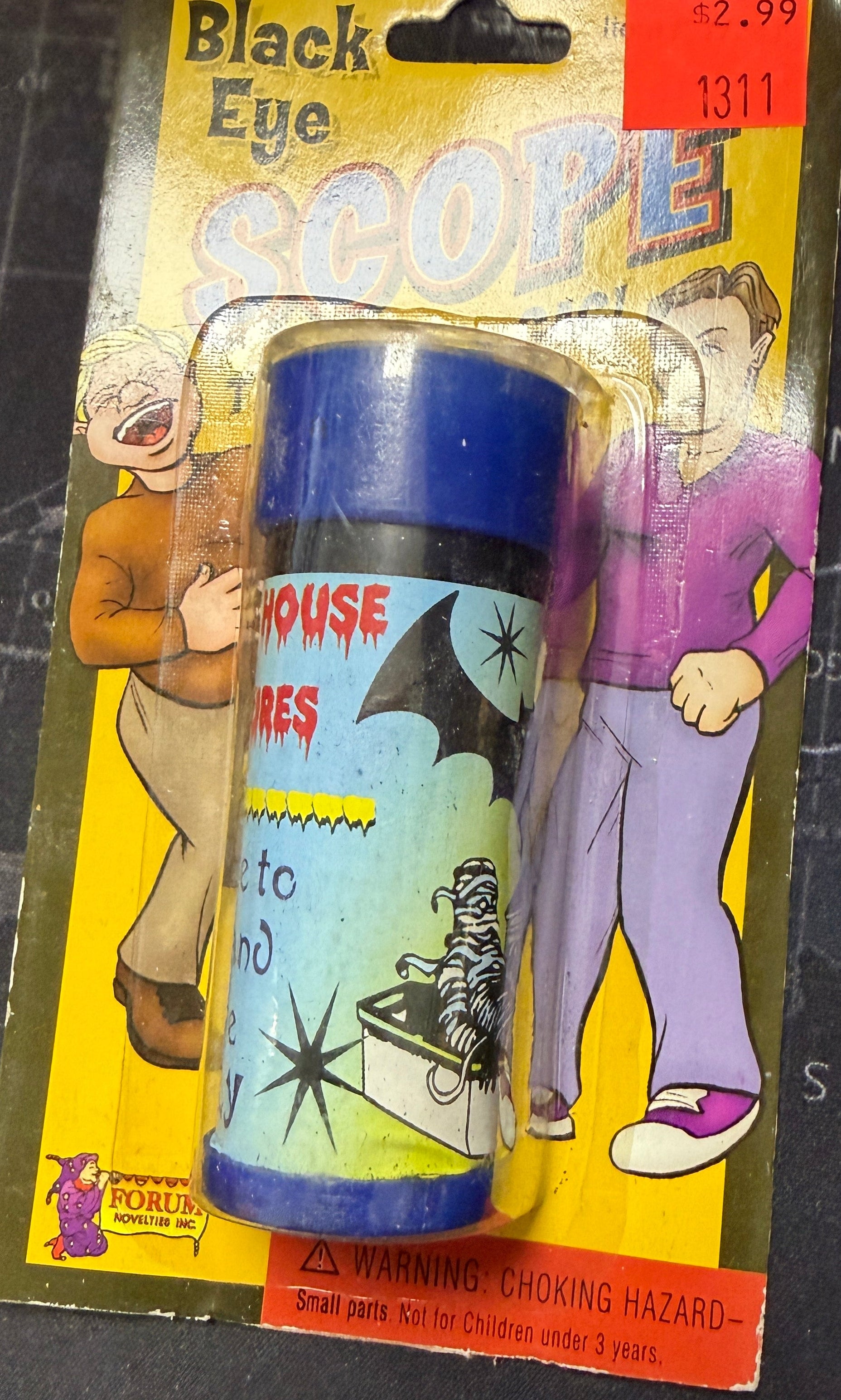 Black Eye Pop toy in packaging on a dark surface