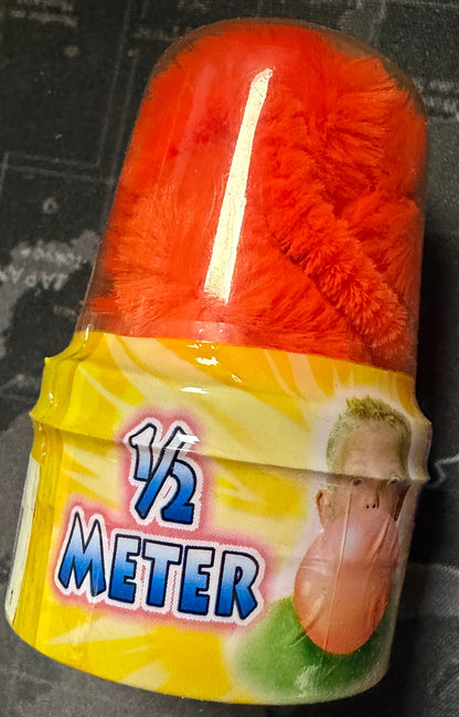 Small cylindrical container with a red top and yellow label on a map background