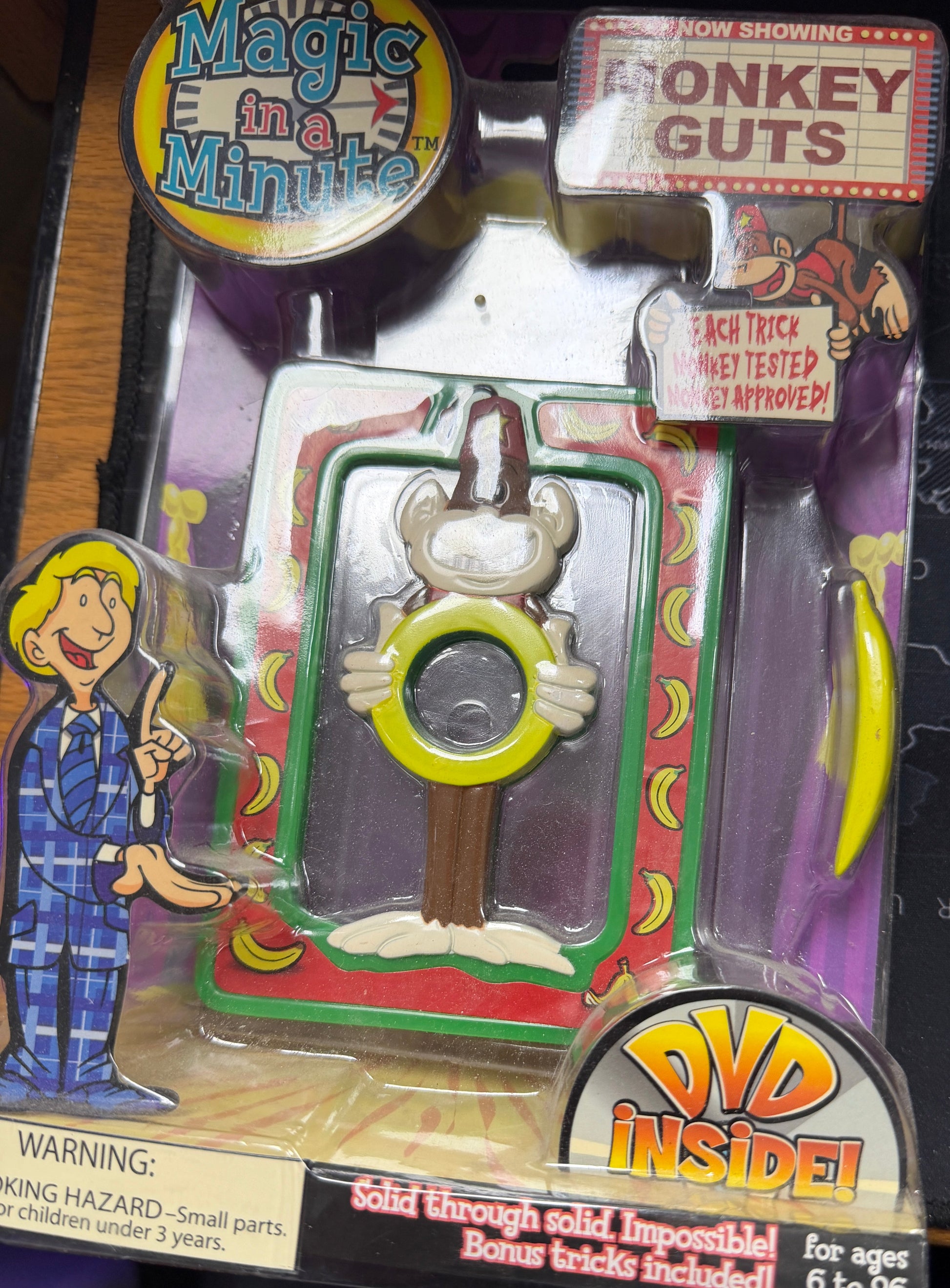 Toy figure in packaging with 'Donkey Guts' and 'Magic in a Minute' branding, featuring a character with a banana.