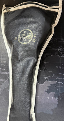 Black golf club head cover with a logo on a map-themed surface