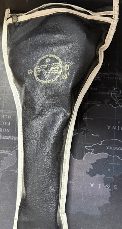 Black golf club head cover with a logo on a map-themed surface