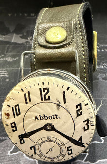 Vintage-style wristwatch with leather strap on a map background