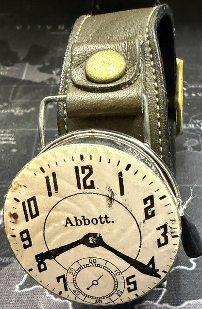 Vintage-style wristwatch with leather strap on a map background